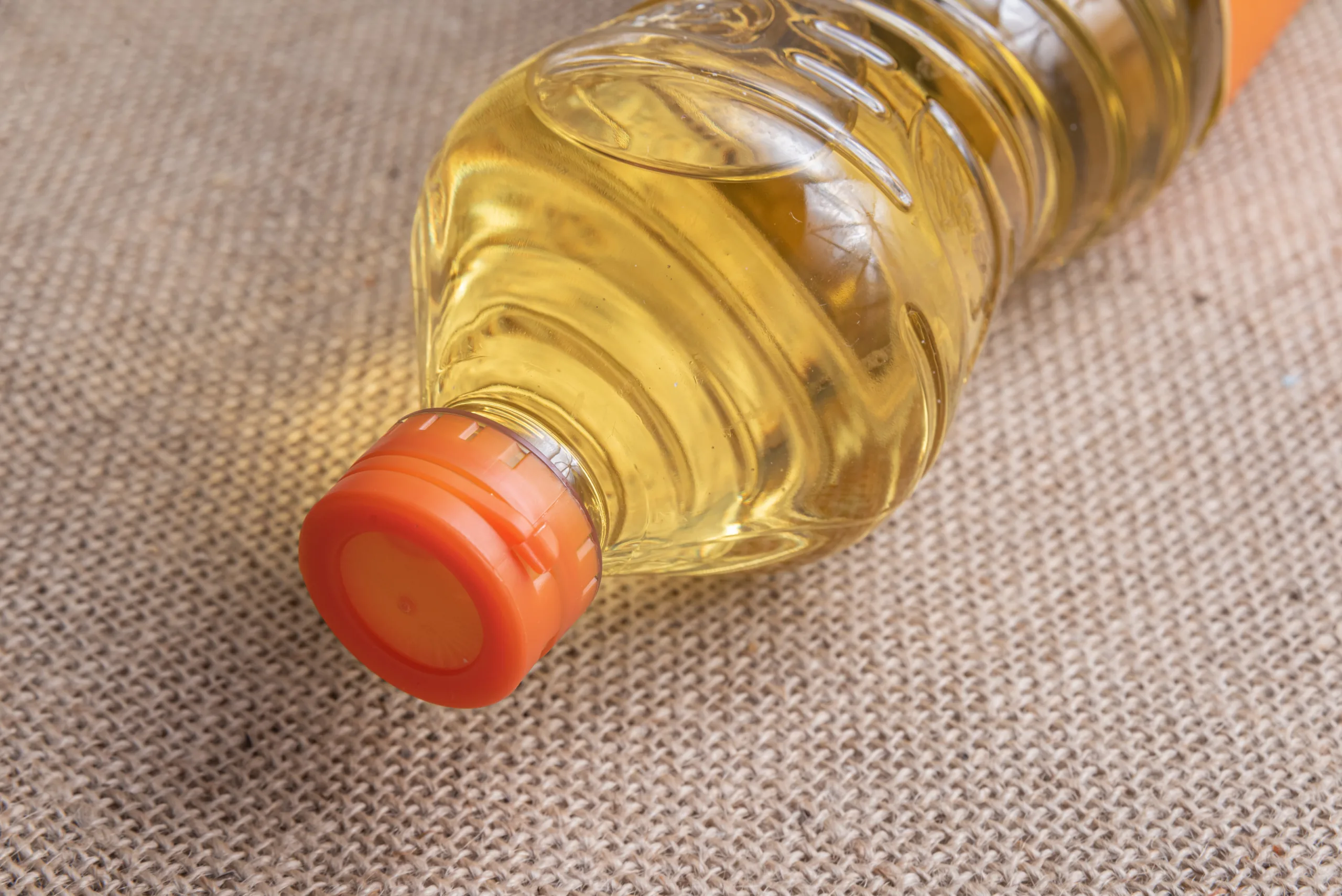 Cooking oil on the brown jute background