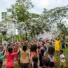 O artista Pedro Lindmayer, o Pedro Bolha, brinca com grupo de crianças fazendo bolhas de sabão ao ar livre em uma praça.