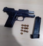 Suspeito baleado em confronto foi identificado como membro de facção criminosa; arma estava com munições e brasão da PM.